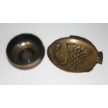 A Japanese bronze fish and an Islamic bowl.