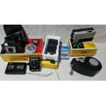 A box of cameras and accessories including Kodak Brownie 127, Kodak Instamatic M4 movie camera, Baby