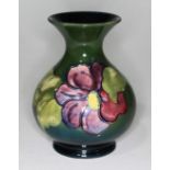 A Moorcroft pottery vase, paper label to base, height 13cm.