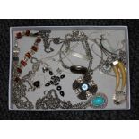 A tray of assorted silver and white metal jewellery.