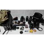 A box of cameras and accessories including Yashica FX-3, Voightlander Vito B, lenses, Sun Actinon