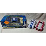 An RC Subaru Impreza car and 2 tin cars.