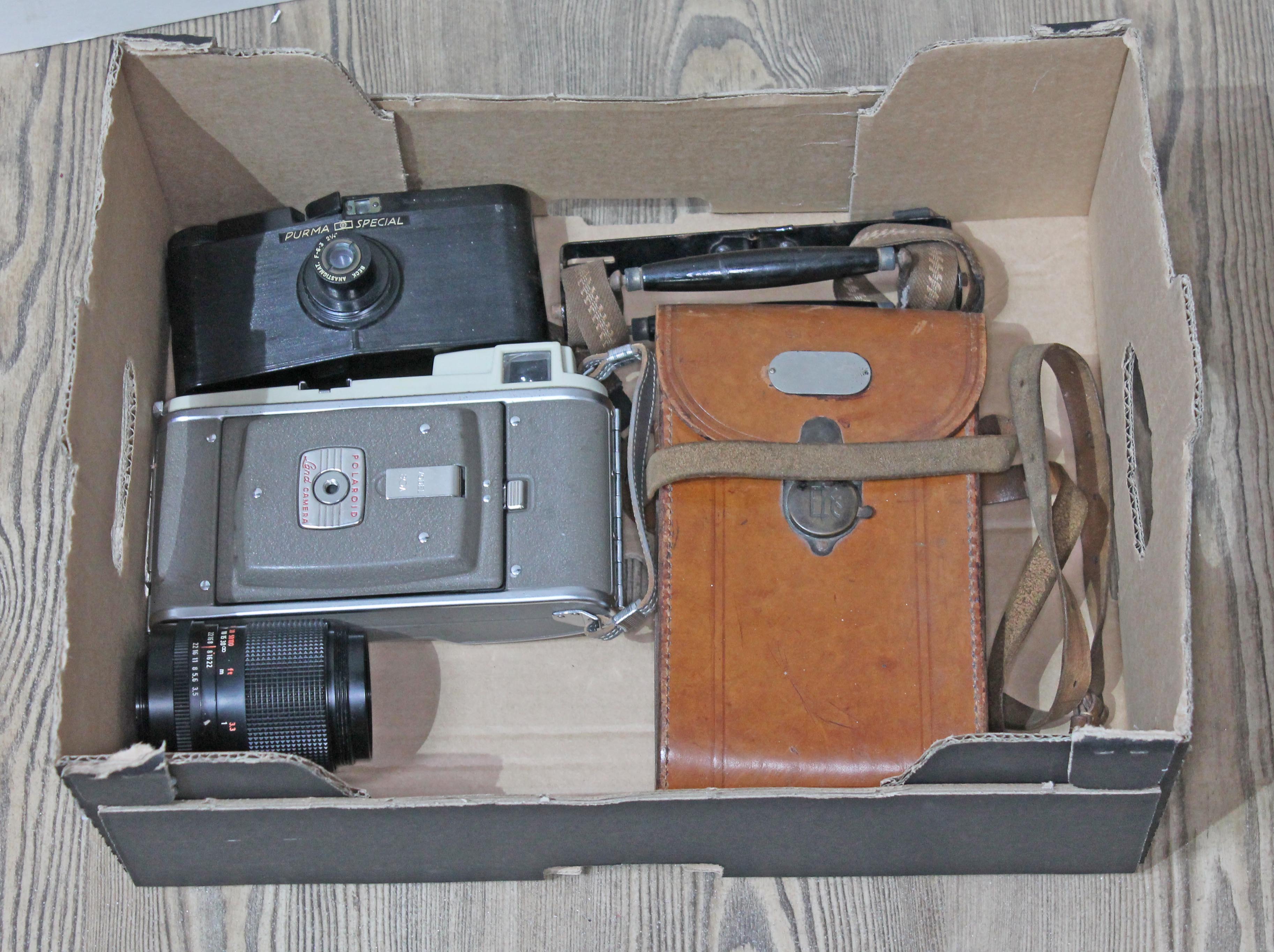 A vintage Polaroid 80A Land camera & Purma Special bakelite camera & Zeiss 135mm lens, etc.