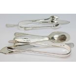 A mixed lot of hallmarked silver comprising a pair of sugar tongs, a spreader and four tea spoons,