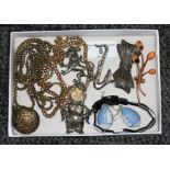 A tray of assorted costume jewellery comprising a yellow metal guard chain with base metal coin