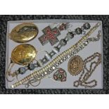 A tray of assorted jewellery comprising rolled gold lockets, a siam bracelet marked 'Sterling',