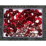 A tray of assorted cherry plastic beads.