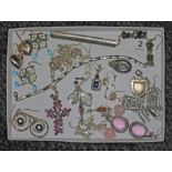 A tray of assorted costume jewellery comprising earrings, pendants, some items marked '925', a