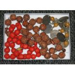 A tray of assorted necklaces comprising cinnabar lacquer and carved wood beads, and an eastern