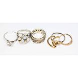 A mixed lot of rings comprising two hallmarked 9ct gold (one cut) weight 3.38g, an eternity rings