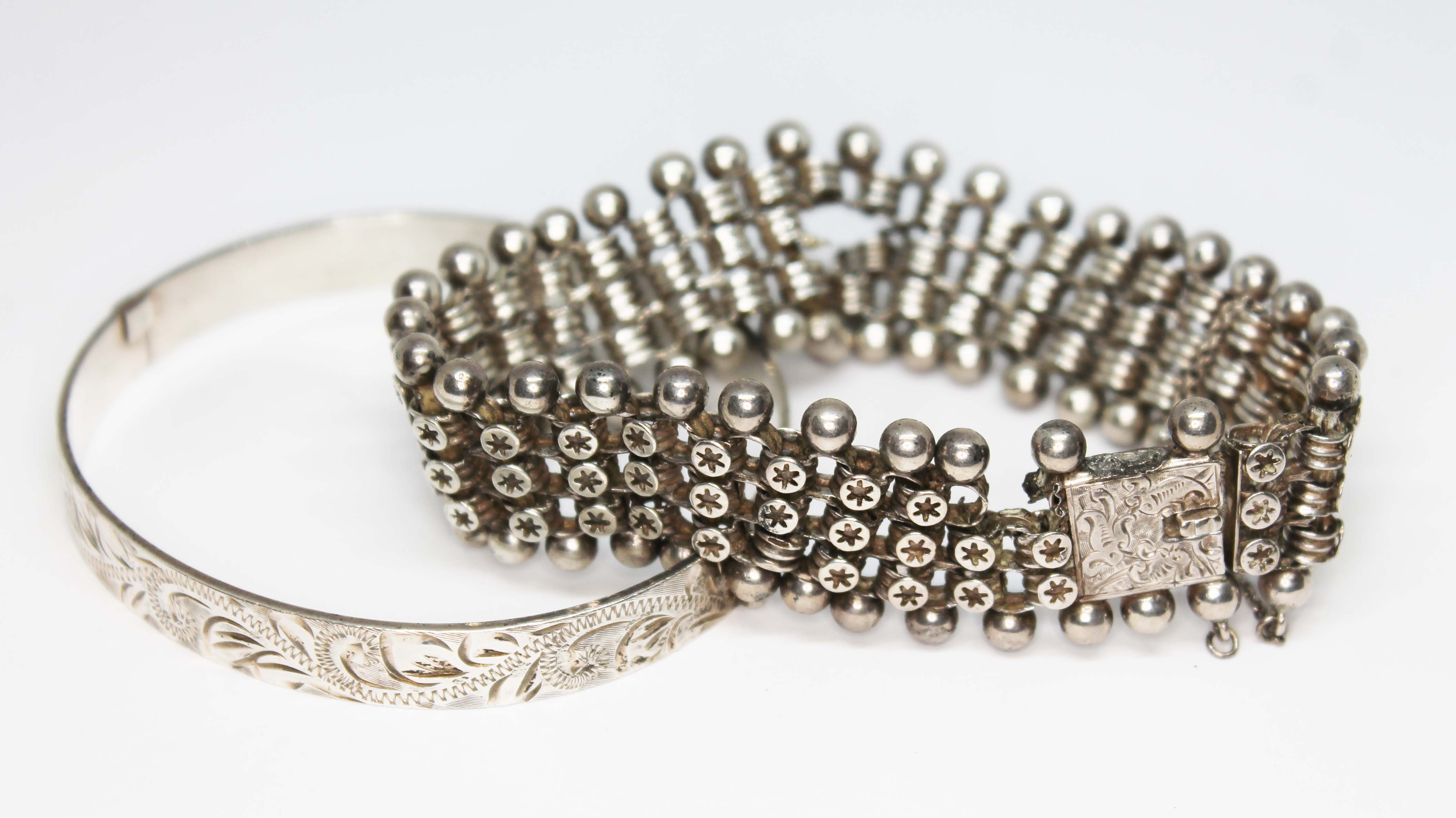 A Victorian white metal bracelet and a hallmarked silver bangle, wt. 44.68g.