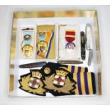 A mixed lot comprising naval badges, Masonic medals and penknives.