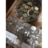 A tub of world coins including 19th century and a sheet of French francs.