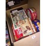 A box of various tins containing matches and beermats + a jigsaw and an old game.