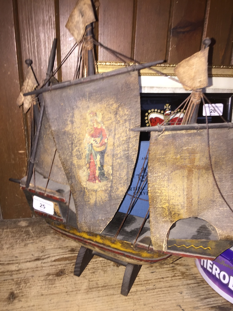 A poly-chrome decorated wooden model galleon, circa 1900, with painted sails.