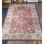 An eastern wool carpet, red ground decorated with flowers, 184cm x 122cm (approx).