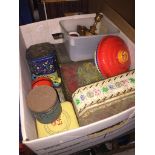 A box containing vintage tins, spinning top etc.