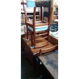 A reproduction mahogany drop leaf dining table and four chairs.