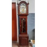 A reproduction mahogany long cased clock with pendulum and weights by Fenclocks.