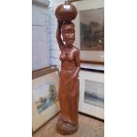 An African carved wood figure of a woman.