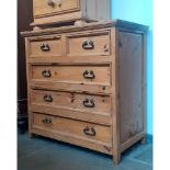 A pine chest of drawers.