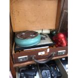 A leather case circa 1930 containing assortment of collectables including two Buddhas.