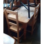 A pine dining table and four chairs.