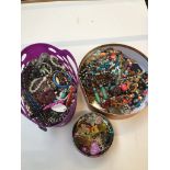 A box and a plastic basket of costume jewellery, necklaces, bracelets, trinkets etc.