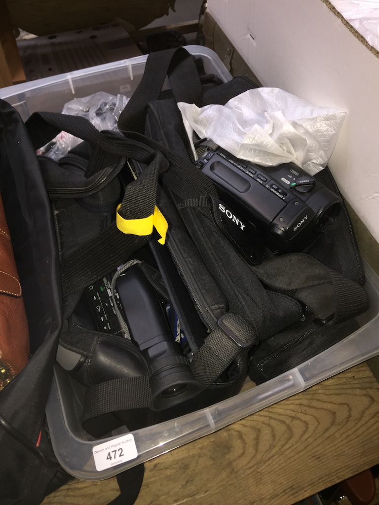 Two video cameras and assorted accessories including flash guns.