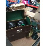 A leather bag containing 2 pairs of crown green bowls nad a set of weighing scales with weights.