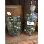 2 jars of various marbles.