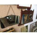 A bevel edged mirror in a carved wooden frame, and another bevel edged mirror