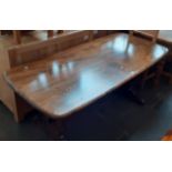 An Ercol dark elm refectory table.