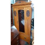 An Edwardian satinwood wardrobe.