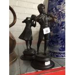A pair of bronze finish cast metal figures, height 25cm.