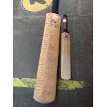 A cricket bat signed by Lancashire Cricket Club players and another small bat