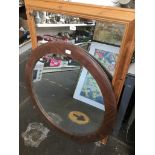 A pine framed mirror and a circular mirror