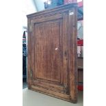 A Georgian oak corner cabinet.