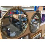 A circular mirror and an oval mirror, both with ornate gilt frames