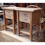 A pair of Laura Ashley light oak bedside cabinets.