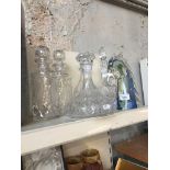 Five glass decanters and a horse ornament