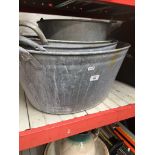 Three galvanised oval metal baths and a galvanised metal bucket.