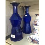 Pair of blue glass bottles with metal rims