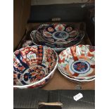 A box of Imari plates and bowls.