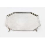 A George V silver salver of octagonal form and stood on four claw feet, Goldsmiths & Silversmiths