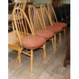 A set of four Ercol light elm and beech high back chairs with original seat cushions.