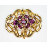 A Victorian brooch of knotted form and set with seven purple garnets, unmarked, 52mm x 40mm, gross