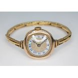 A ladies Tavennes 9ct gold wristwatch with indistinctly signed enamel dial, breguet hands, case