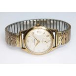 A 9ct gold Garrard wristwatch, case width 33mm, signed champagne dial with seconds subsidiary,