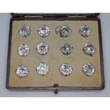 A cased set of twelve paste buttons, early 20th century, white metal unmarked. Condition - good,